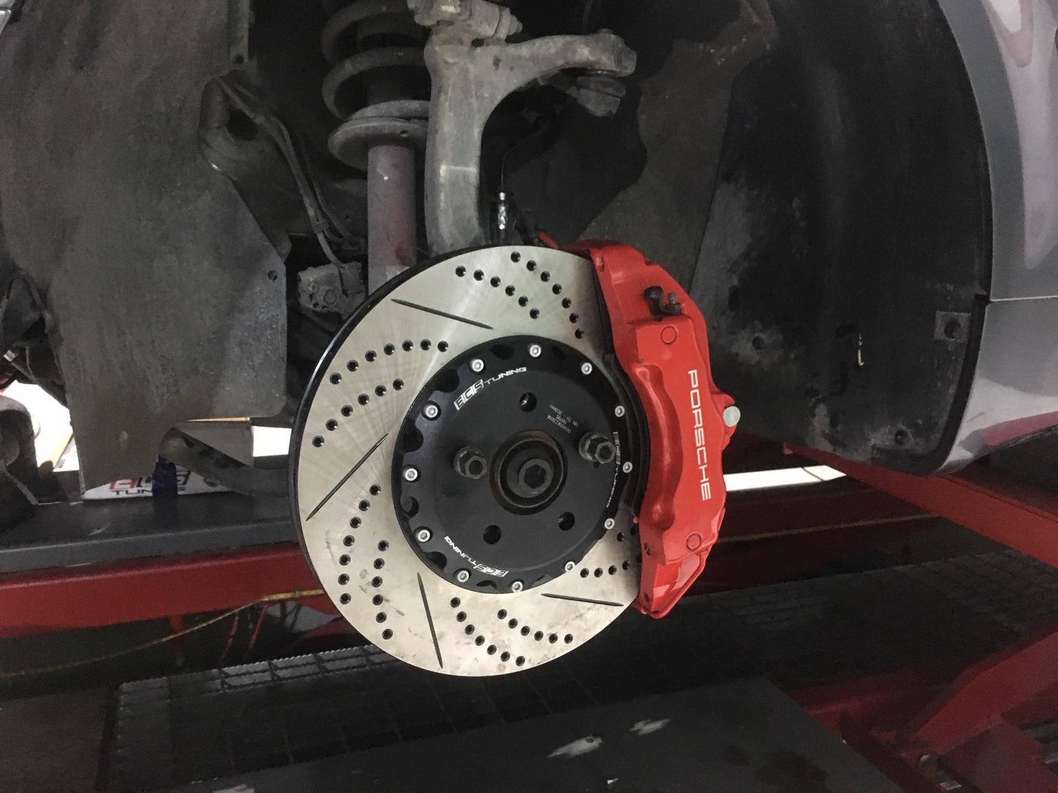 Porsche Cayenne brake caliper and large drilled slotted rotor installed on Hanz