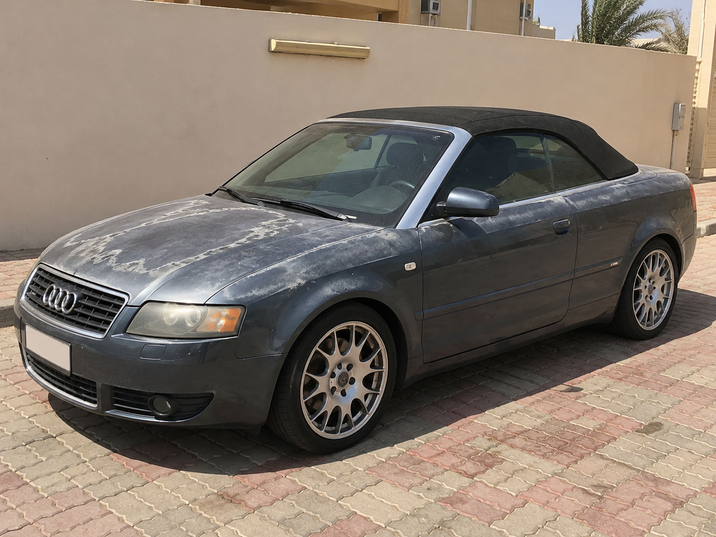 Illustrative recreation of sun-damaged clear coat on a grey Audi Cabriolet